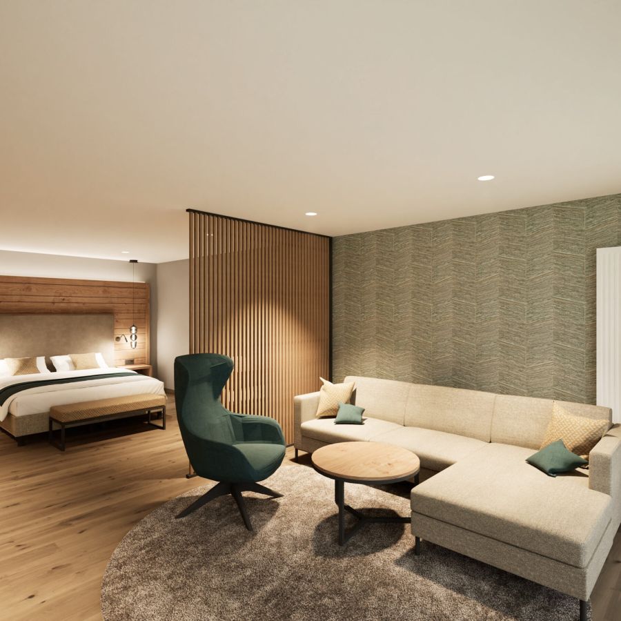 Wohnbereich der Junior Suite mit Ecksofa, Sessel und Doppelbett im Hotel Churfürstenhof
