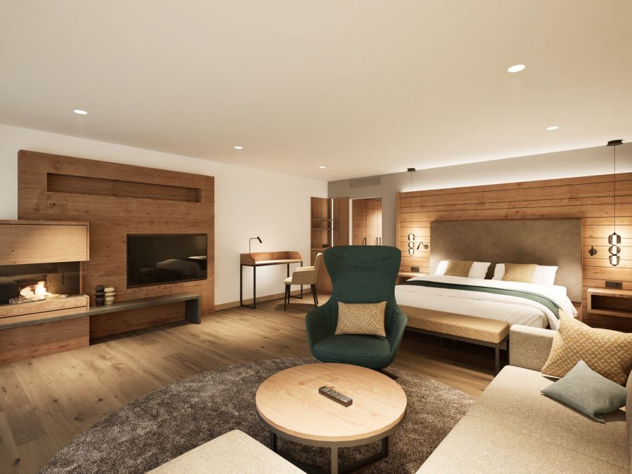 Junior Suite im Hotel Churfürstenhof mit Doppelbett, Kamin, TV und Sitzecke in warmem Holzdesign